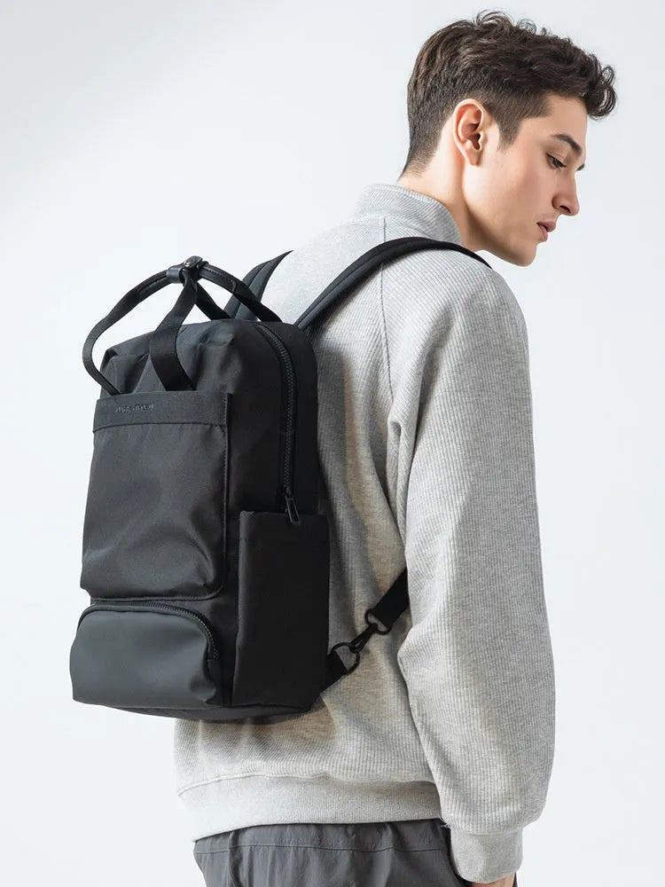 Black Oxford cloth computer backpack showing front view and storage compartments.