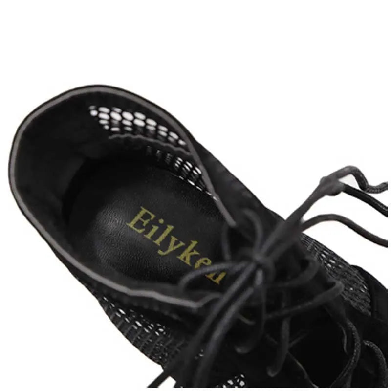 Black suede women's lace-up high heel shoes with an ankle strap, shown from the side on a white background.