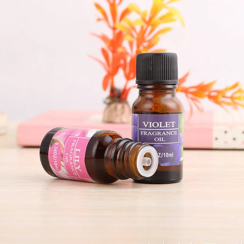 Set of 12 small glass bottles of aromatherapy essential oil, 10ml each, with labels showing Lavender, Rose, Lemon, and other fragrances.