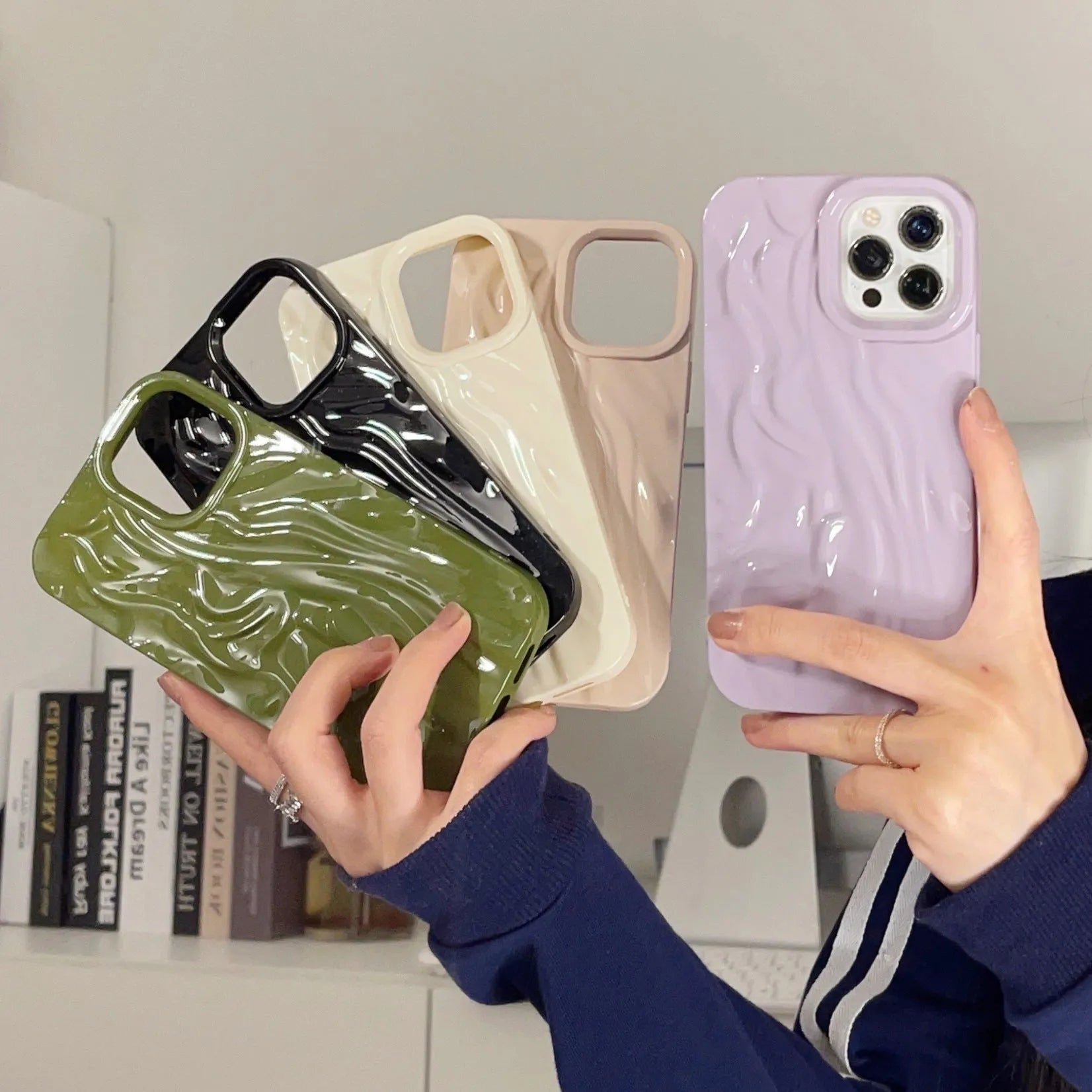 Solid colour water ripple texture silicone phone case for iPhone, shown in milky white, pink, and purple colour options.