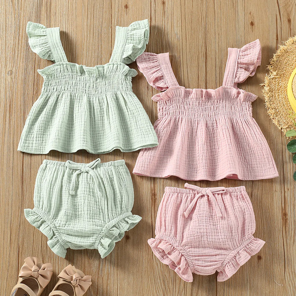 Green cotton girls' two-piece set with sleeveless sling top and matching short hot pants.