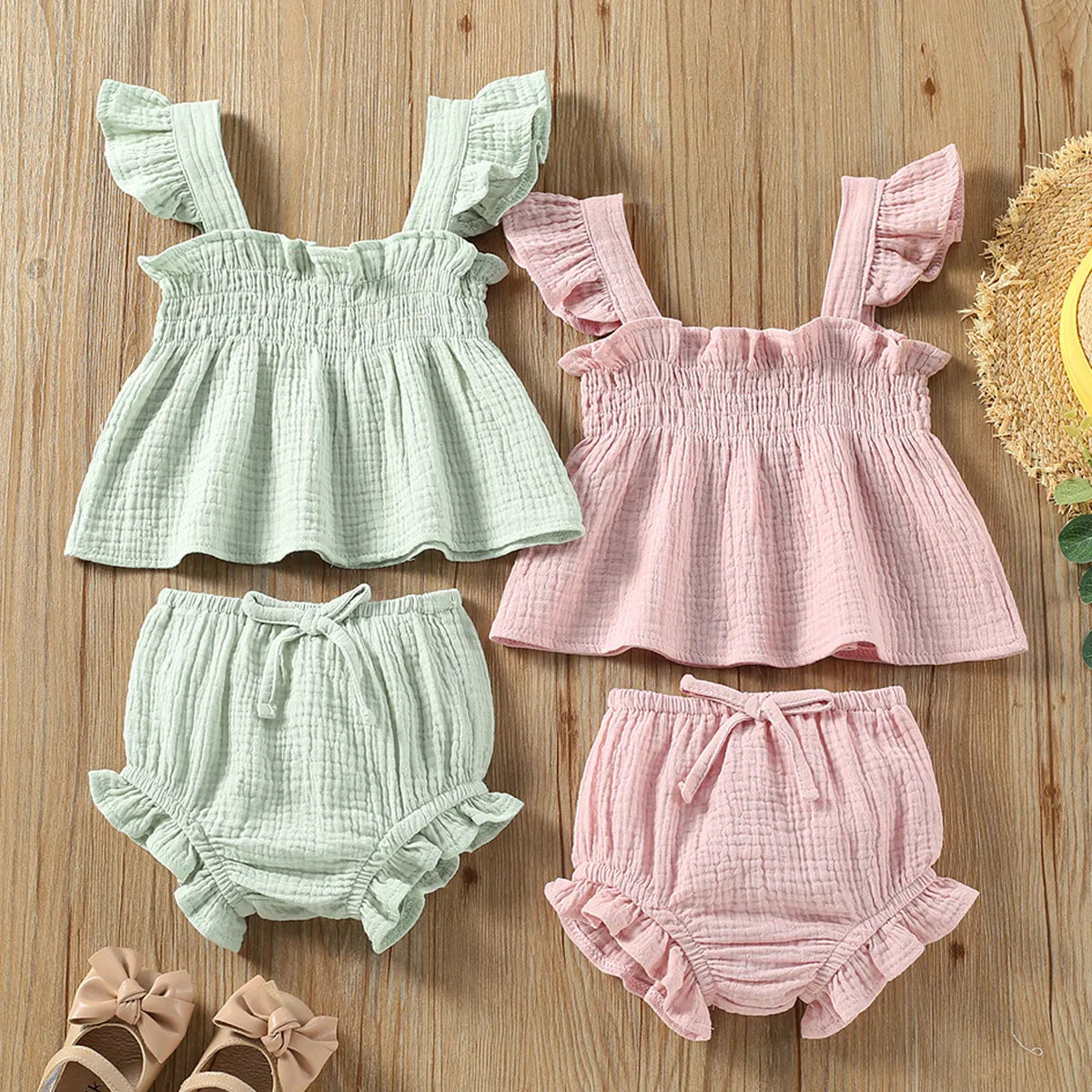Green cotton girls' two-piece set with sleeveless sling top and matching short hot pants.