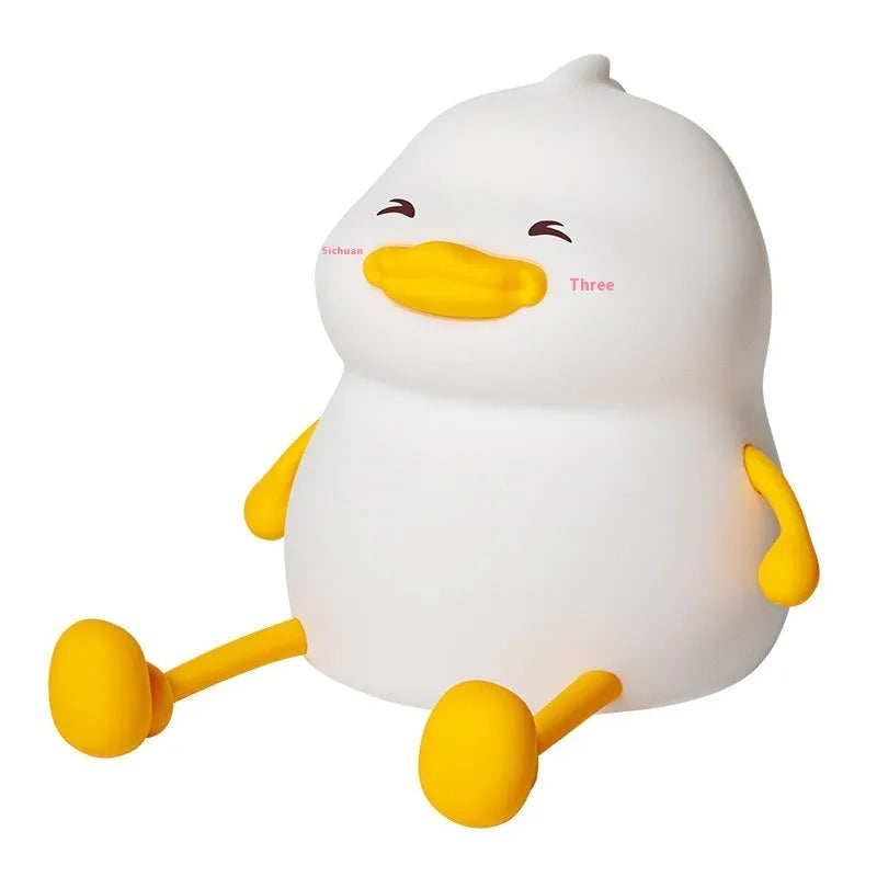 Chubby white USB rechargeable LED night light on a desktop, showing its compact size and soft glow.