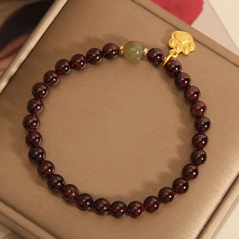 Women's Cat's Paw Garnet crystal bracelet on wrist, original design.