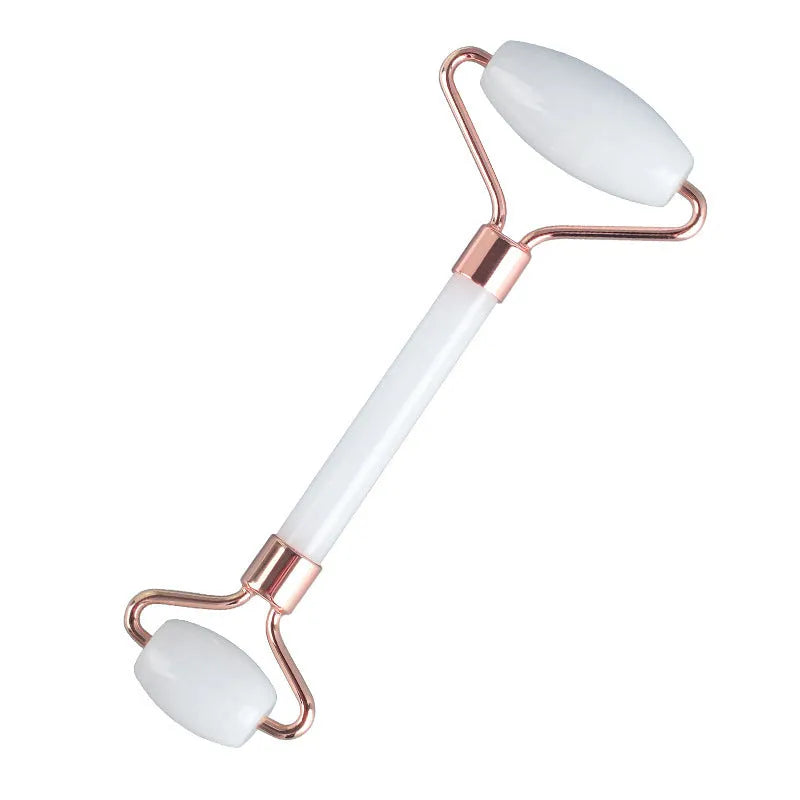 White jade double-headed roller and matching scraping board set on a flat surface.