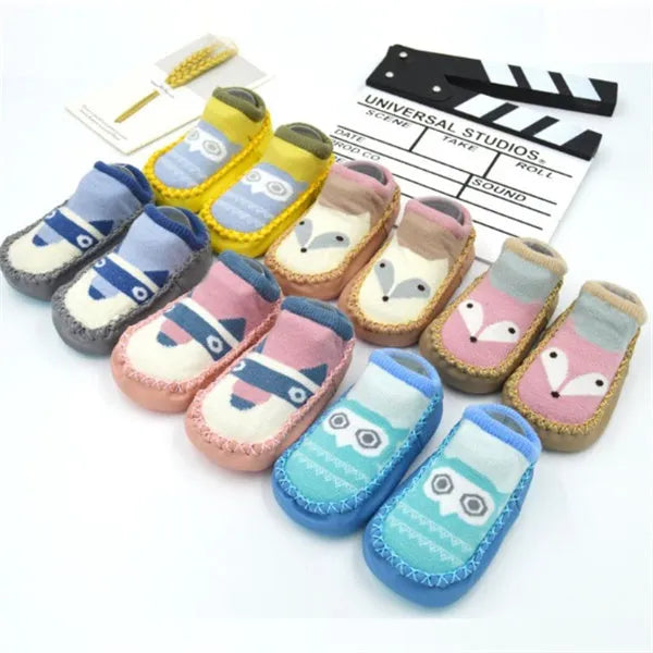 Pair of pastel coloured baby socks with anti-slip dots on the sole, shown flat.