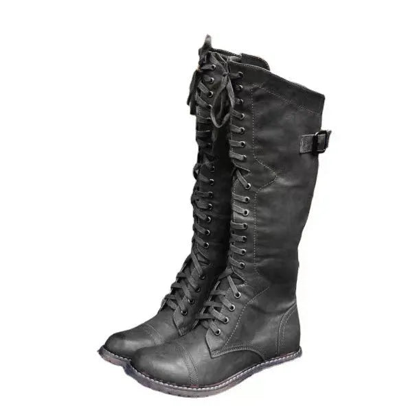 Black chunky heel high leg boots on a white background, showing round toe and stout low heel.