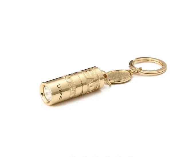 Gold-colour zinc alloy waterproof mini LED flashlight on a keychain ring.