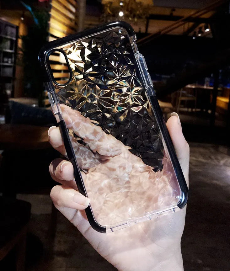 Striped TPU iPhone case shown in black, pink, and white edge colour options on a table.