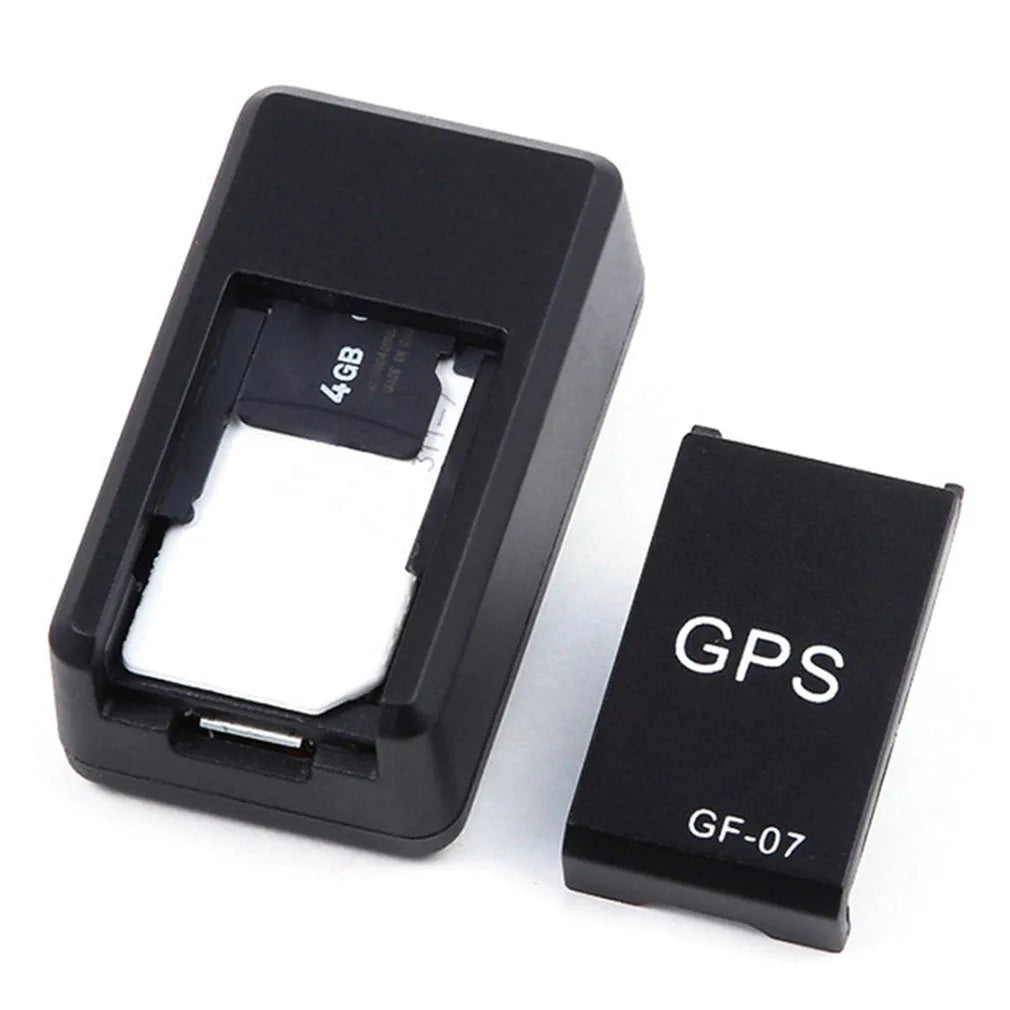 Small black magnetic GPS tracker device with USB cable for real-time vehicle and asset tracking.