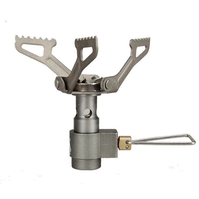 Portable gas camping stove with a one-piece metal furnace body, shown on an outdoor surface.