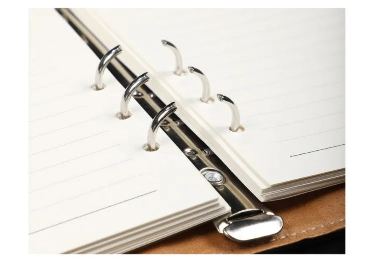 Hardcover A5 leather notebook with buckle closure in five colour options showing interior Daolin paper