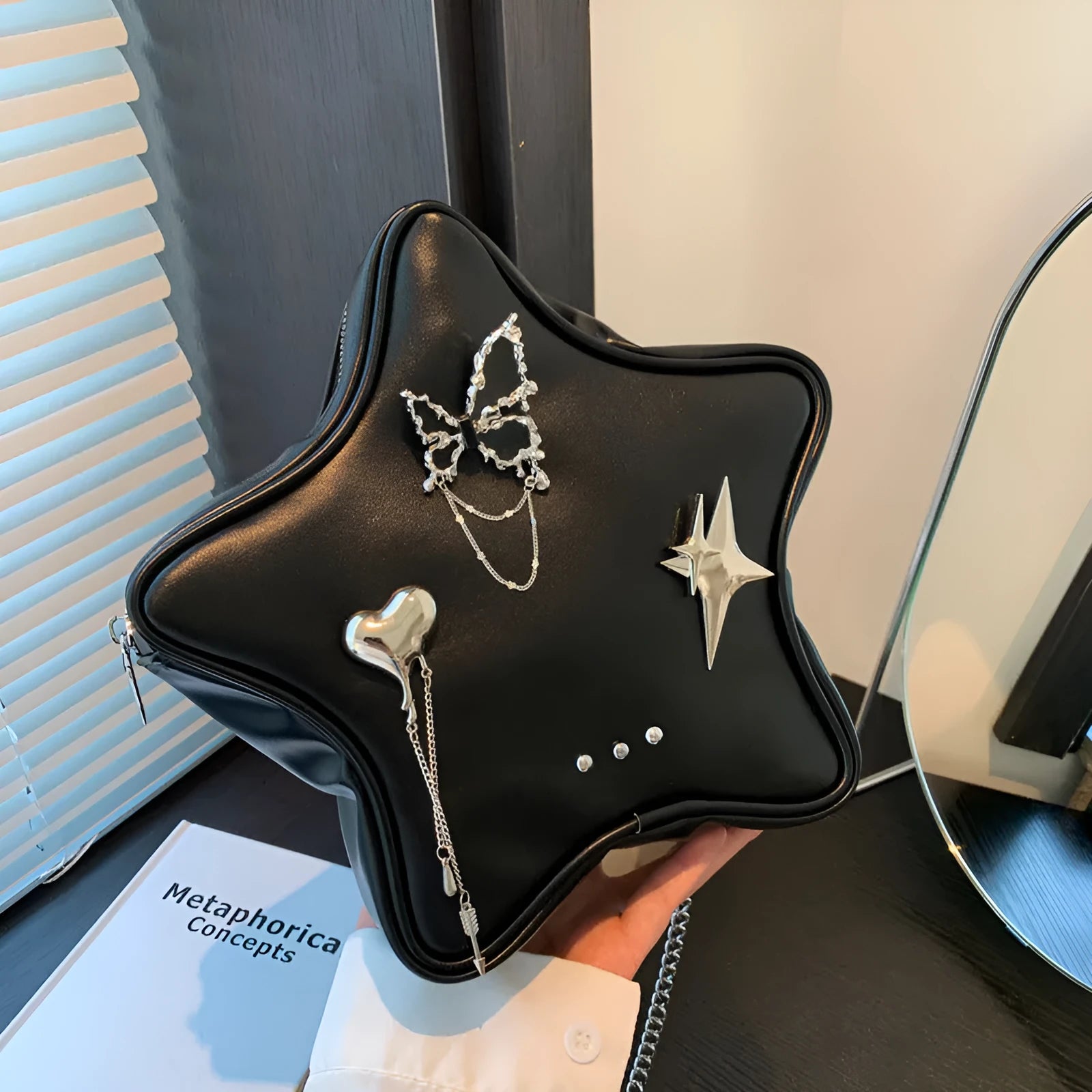 Black PU leather decorative backpack with metal butterfly love pendant and five-pointed star, chain strap.