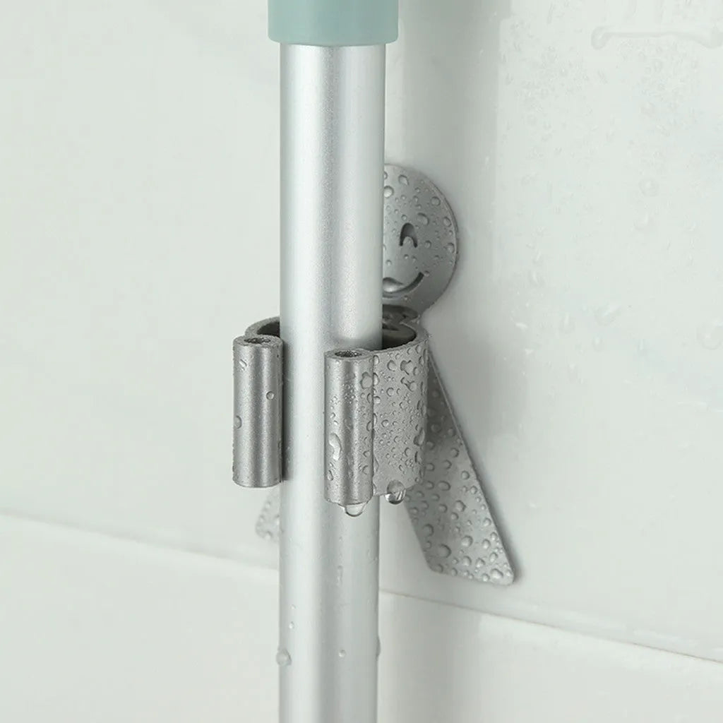White bathroom toilet mop hook with adhesive backing for wall mounting, holding a toilet brush handle