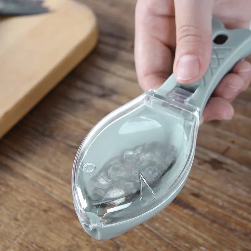 Fish-shaped scale scraper with removable knife and containment cover