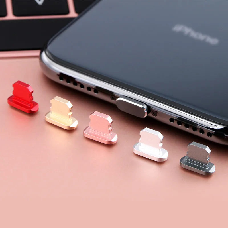 Aluminium alloy charging port dust plug for iPhone in various metallic colours including gold and rose gold.