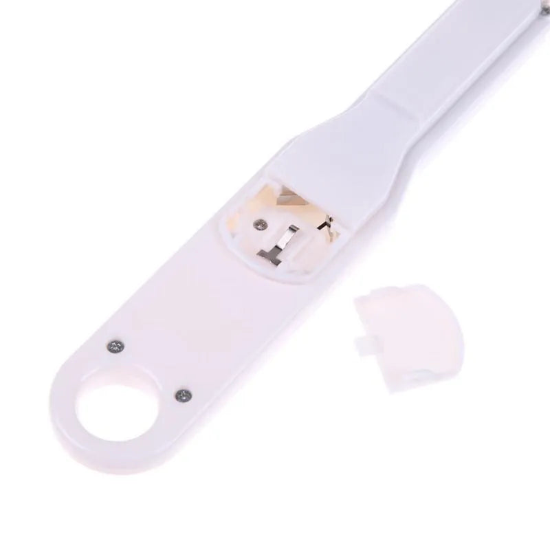 White digital spoon kitchen scale with LCD display showing weight measurement.