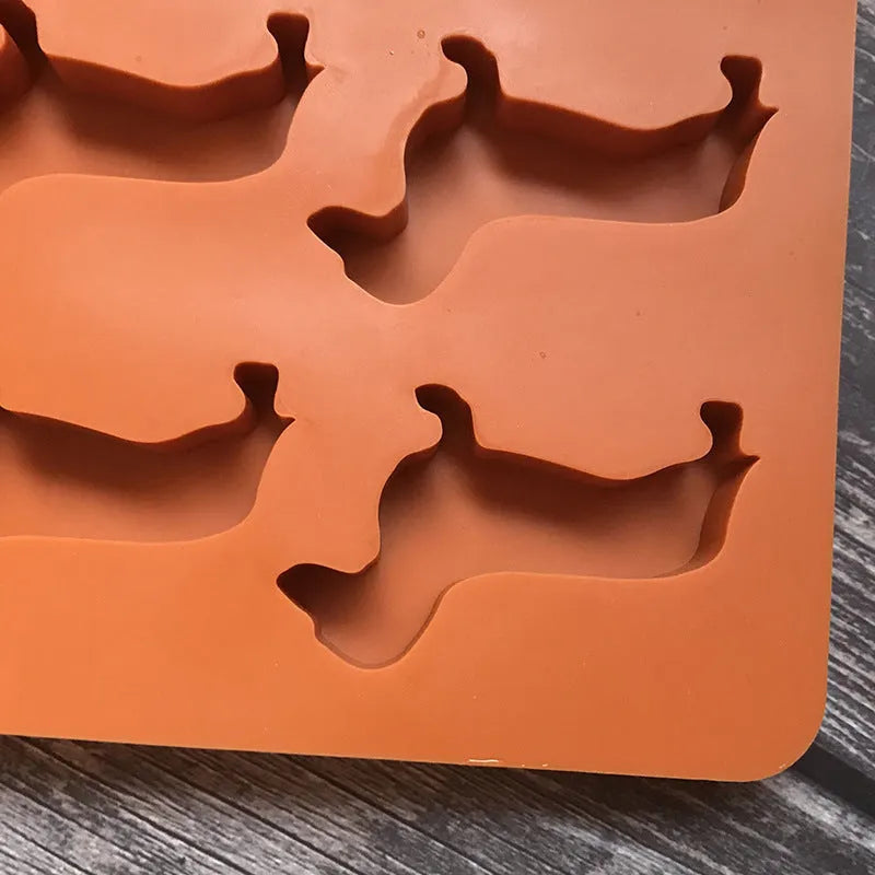 Orange silicone ice mold producing animal-shaped ice cubes for creative drinks