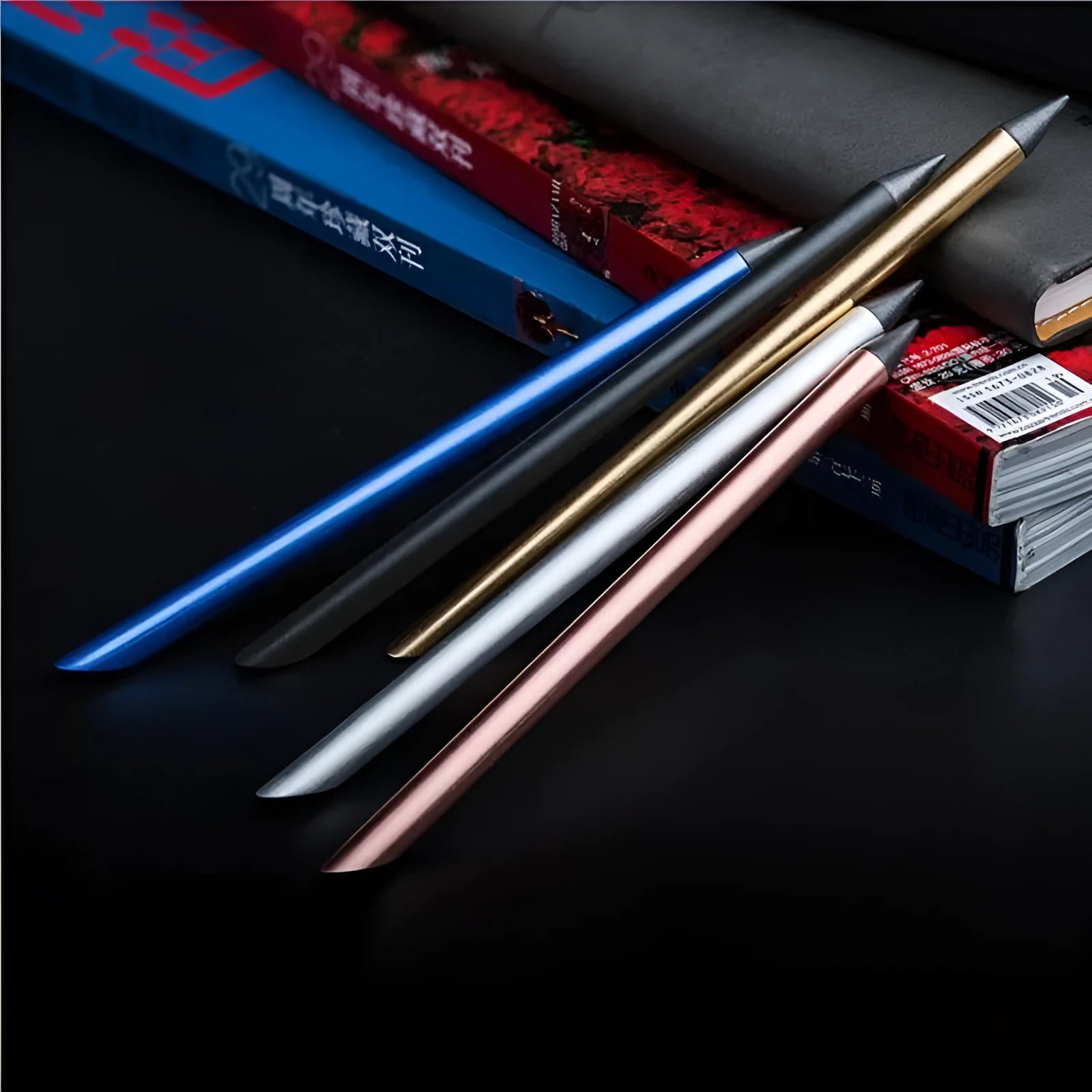 Silver Inkless Metal Pen with 0.5mm alloy tip, spare nib, and pen bag on wooden desk