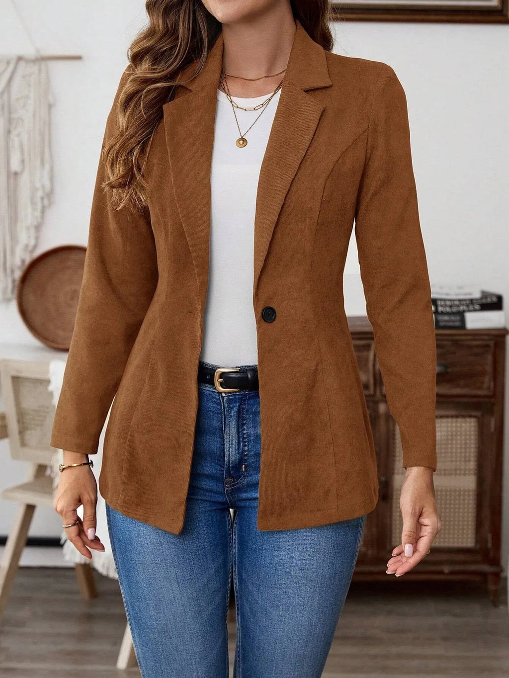 Brown men's single-breasted blazer with lapel collar and long sleeves on a hanger.