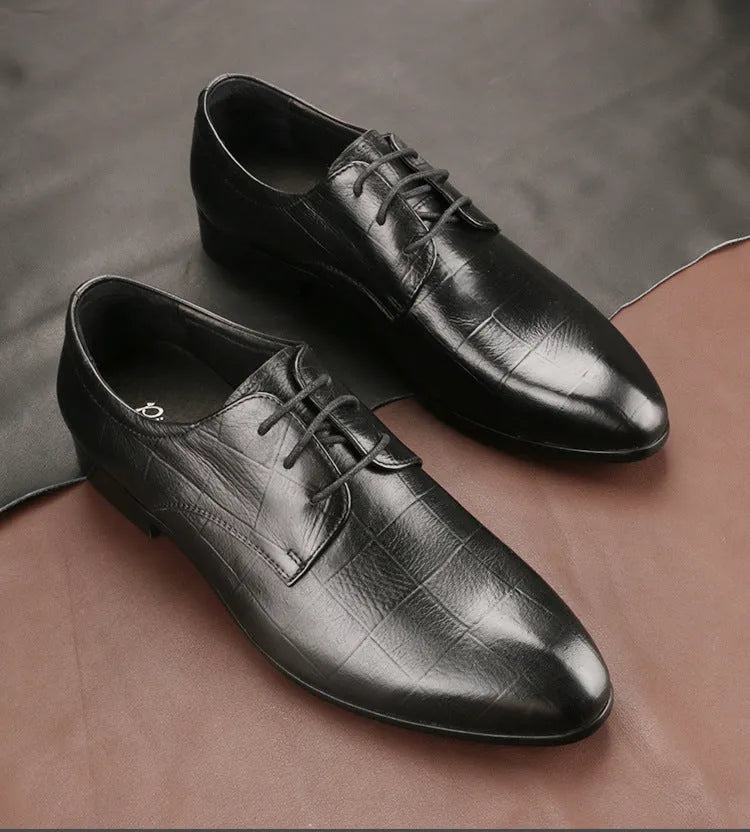 Men's black checkered leather derby shoes with a pointed toe and rubber sole on a white background.