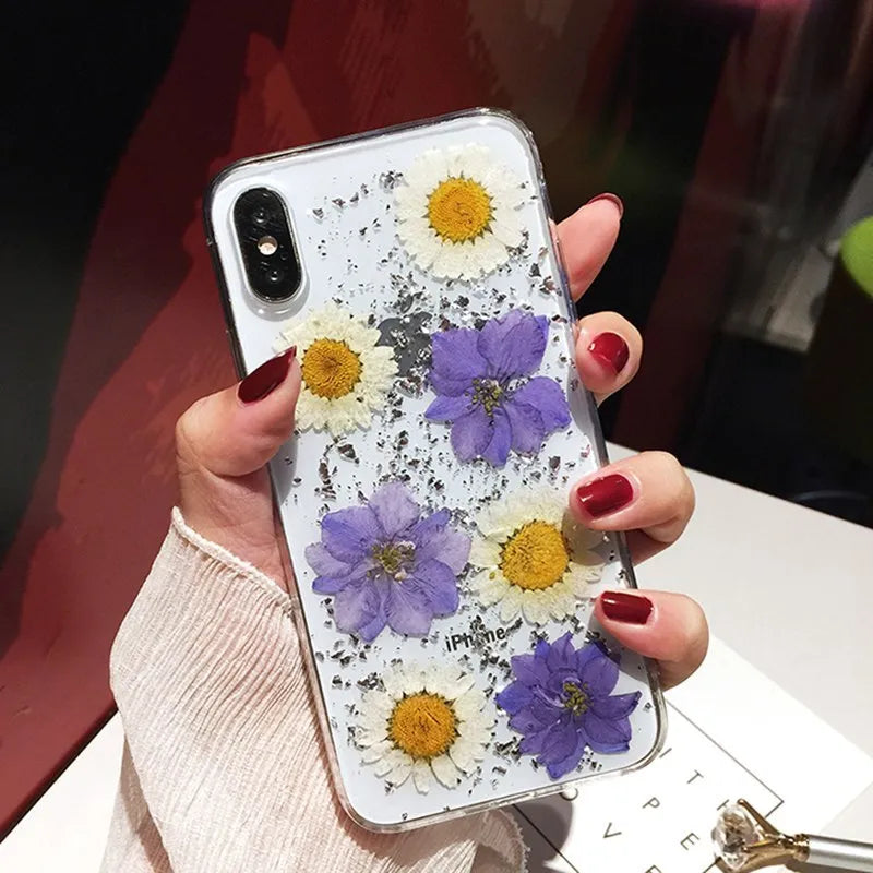 Clear iPhone case with real pink dried flowers preserved under glossy epoxy resin.