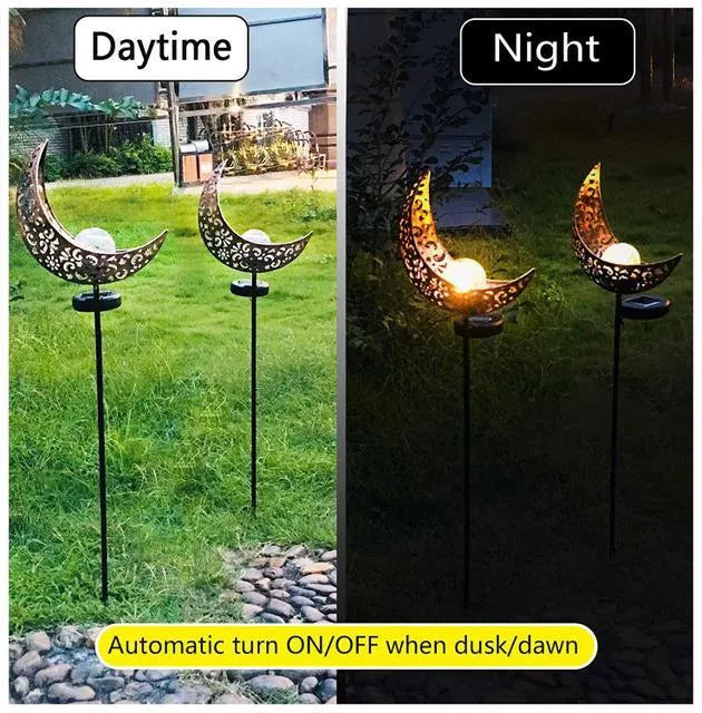 LED solar flame light with warm white glow, iron construction, and glass globe in an outdoor garden setting