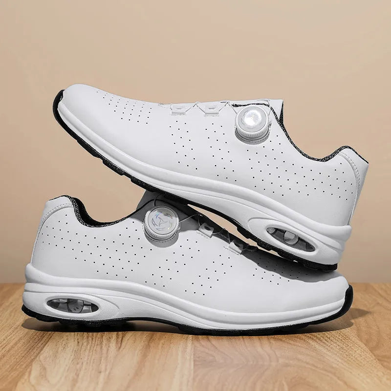 Man's black and white low-top casual tennis shoes with mesh upper and cross shoulder straps.