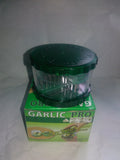 Green transparent plastic garlic peeler kitchen gadget on a counter.