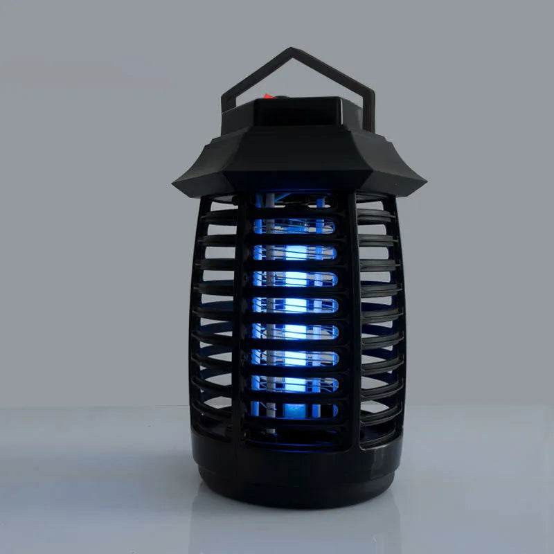 Black aromatherapy mosquito killer lamp with a glass UV tube on a table.