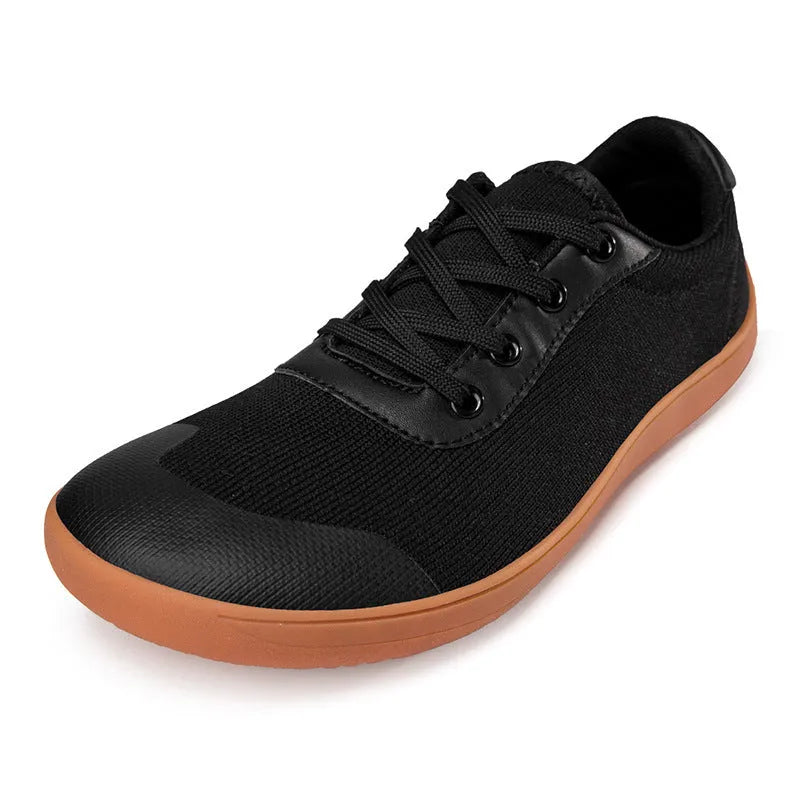 Men's solid-colour training shoes with a mesh upper, wide fit, and ribbed non-slip sole.