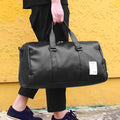 Black unisex waterproof sports bag with a separate shoe compartment and diagonal straps.