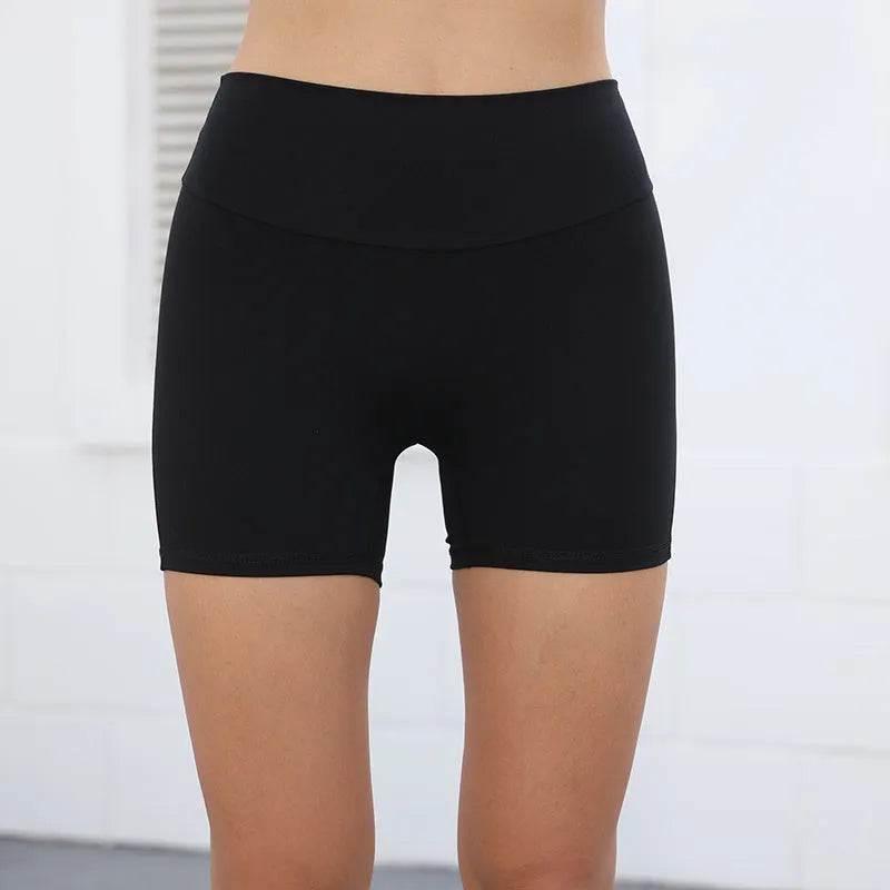 Women's high waist hip lifting fitness shorts in a solid colour with side pockets, on a mannequin.