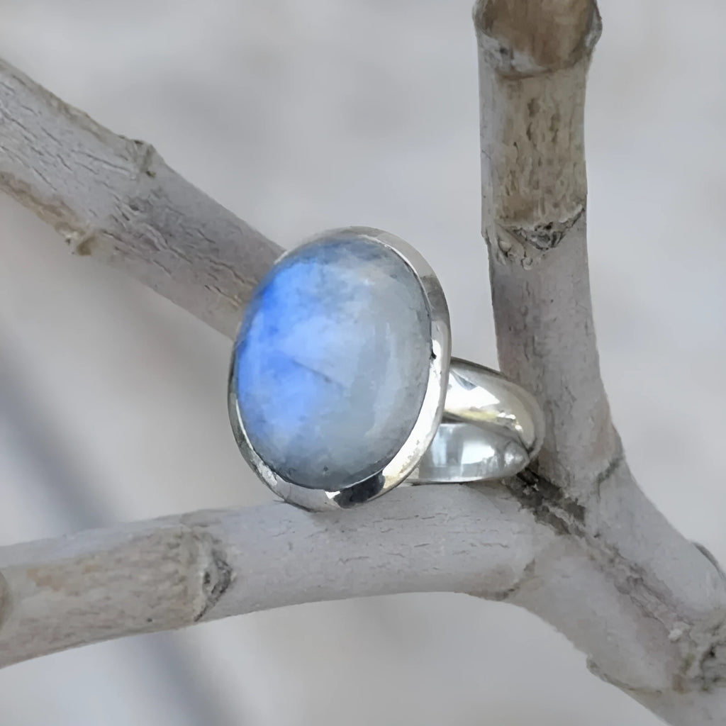 Silver alloy vintage Thai moonstone flower ring for women on plain background
