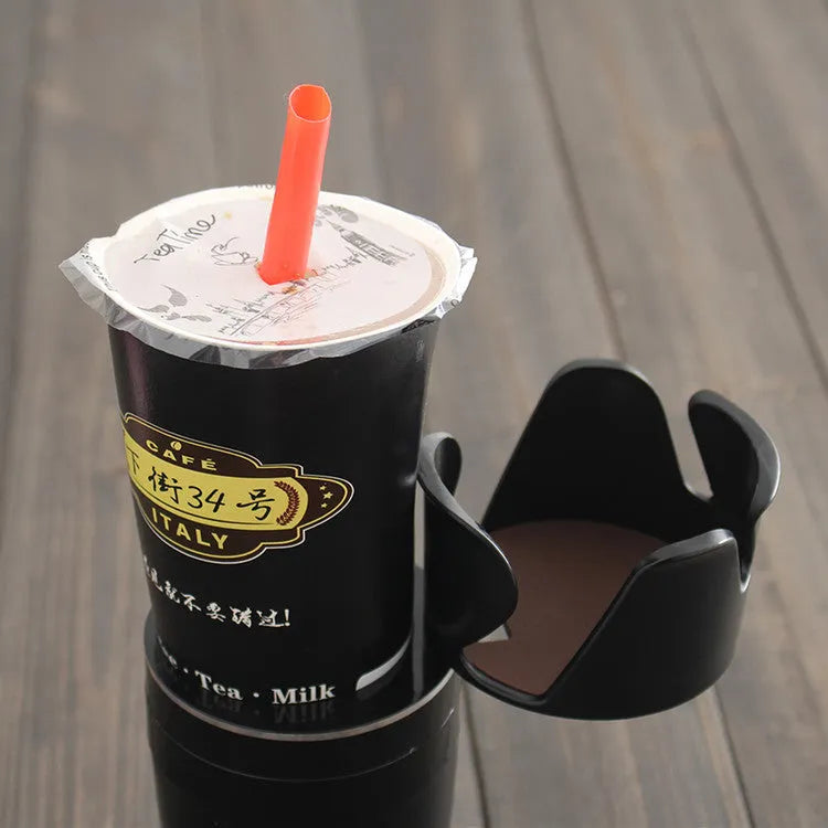 Black multifunction car cup holder with attached navigation phone mount bracket.