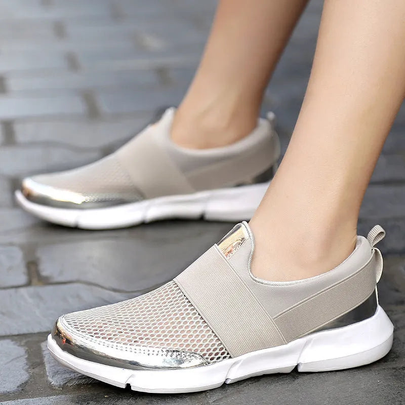 Women's blue breathable sneakers with mesh lining and low-tube design on hard floor surface