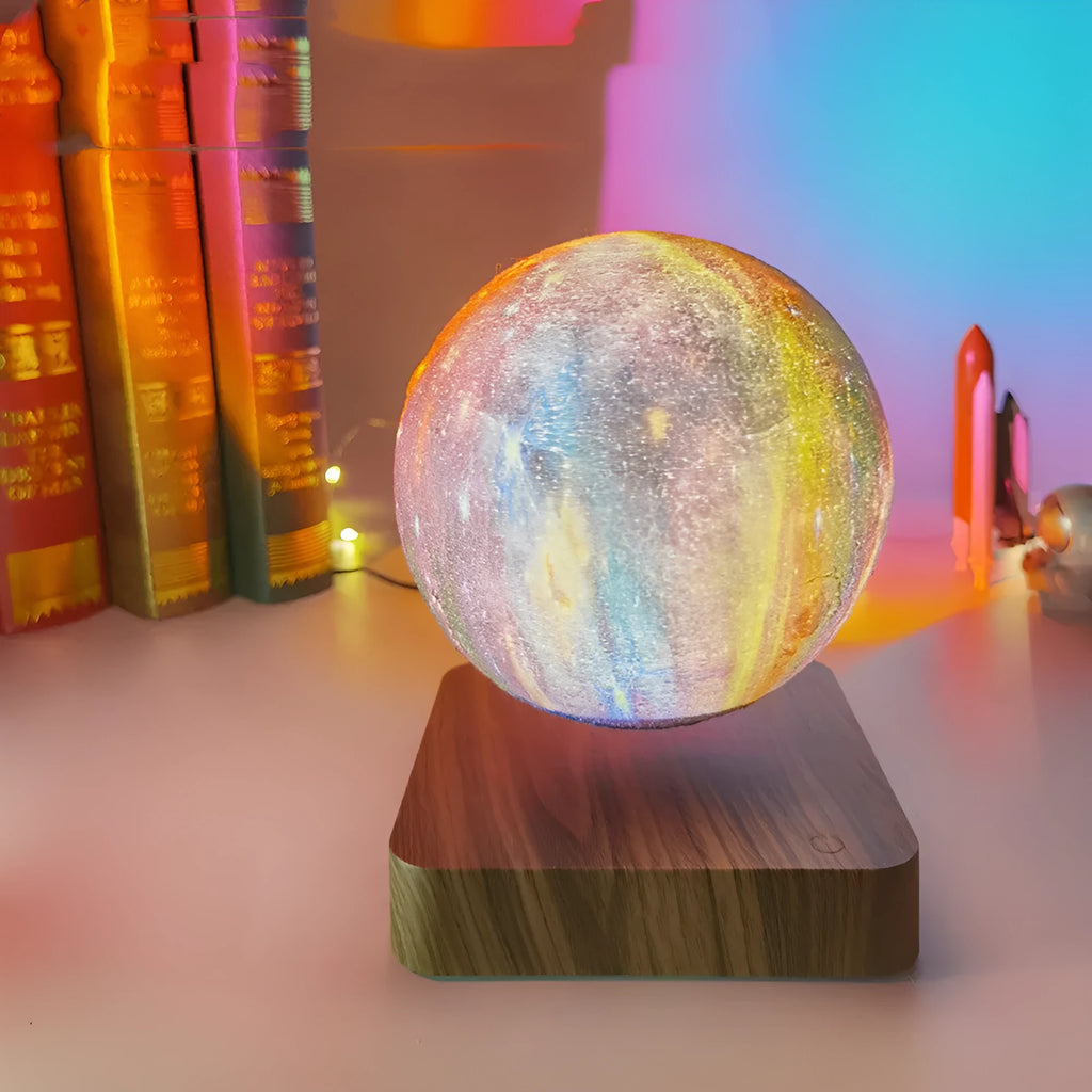 Walnut-coloured magnetic levitation base with floating galaxy-patterned moon lamp illuminated in dark setting