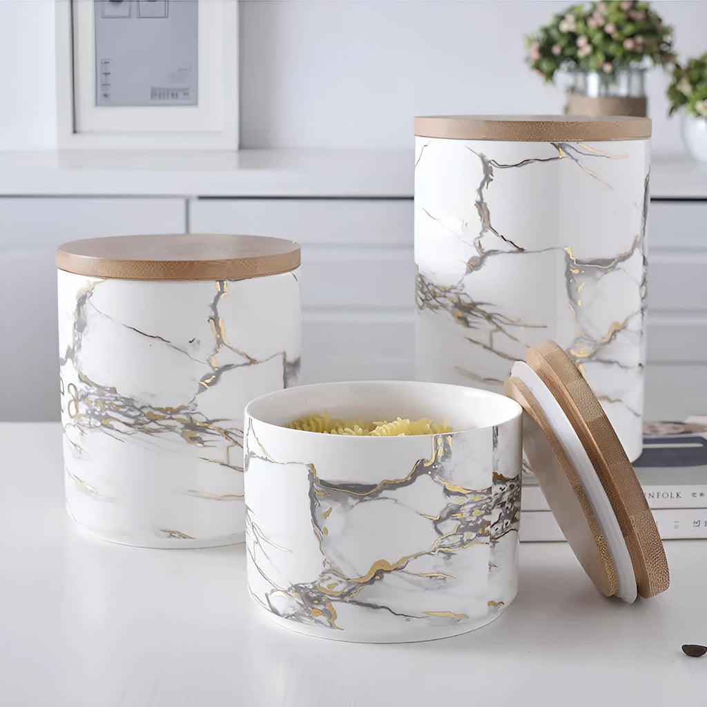 3 piece marbled ceramic jar set with wooden lids large medium and small on a countertop