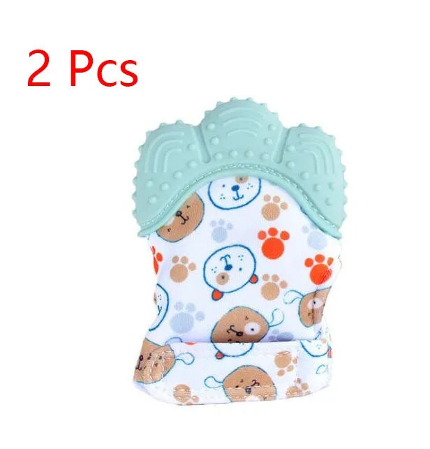 BPA-free silicone baby teether glove fastened with a white Velcro strap on a baby's hand