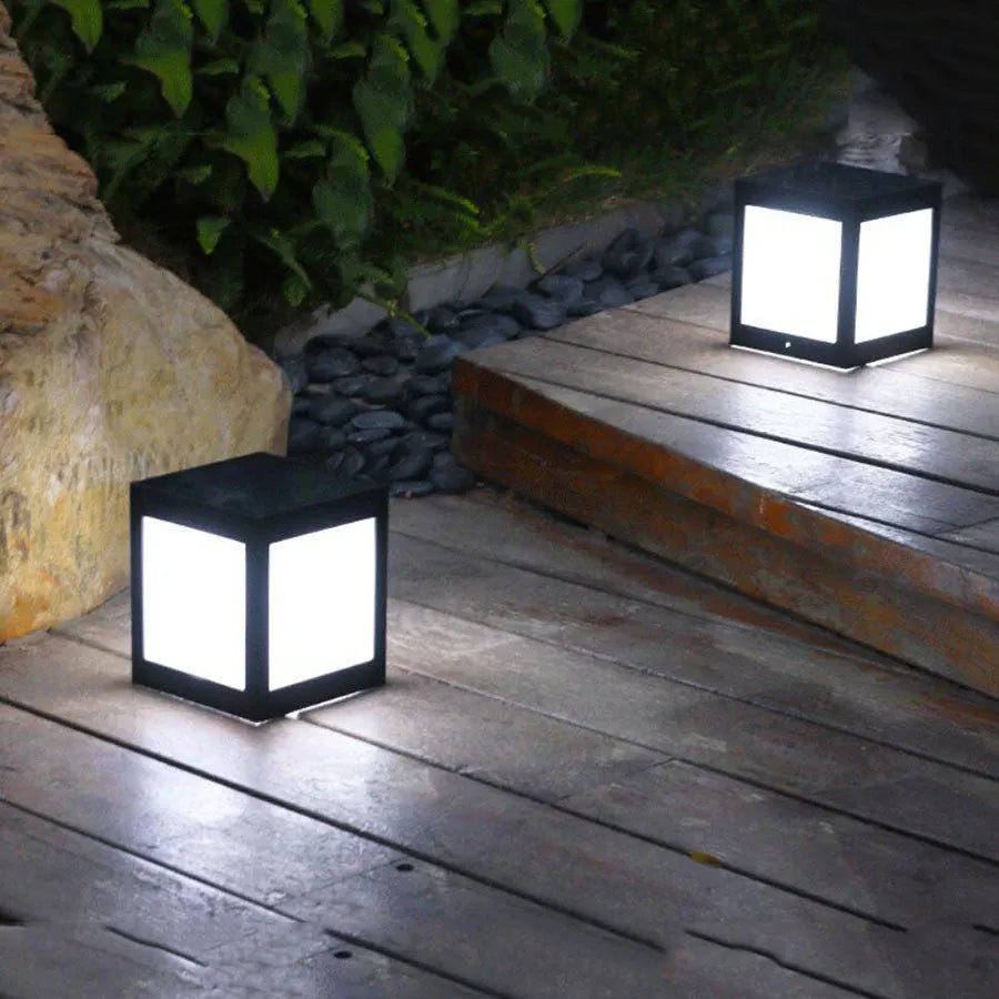 Waterproof solar garden light with LED, stake, and solar panel in a UK garden setting