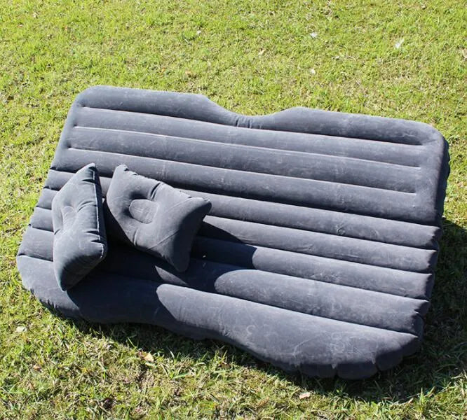 Black thickened flocking inflatable car bed set up in a vehicle with pillows.