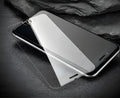 Tempered glass screen protector for mobile phones with 9H hardness and oleophobic coating.