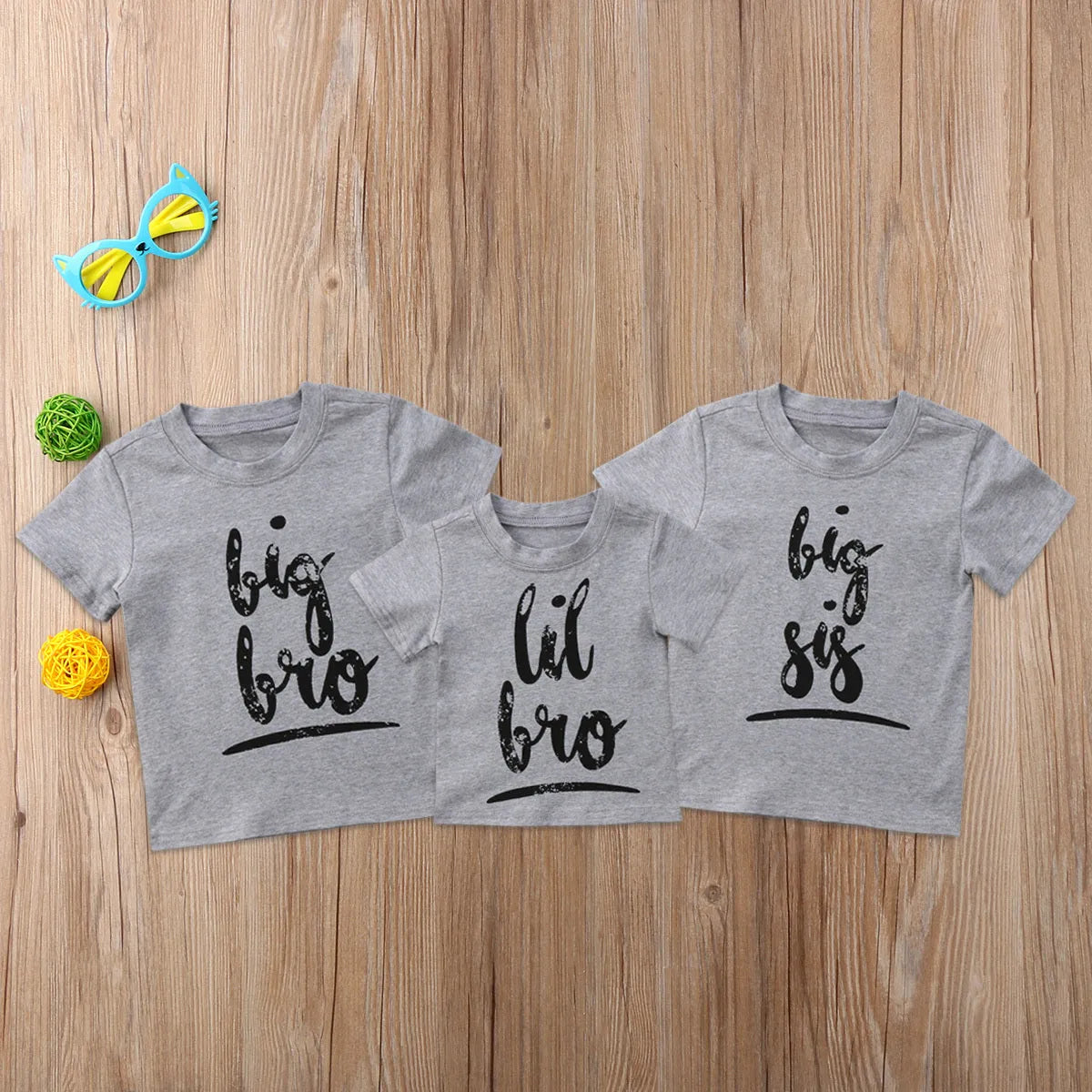 Grey printed cotton t-shirt shown in sizes for children and adults.
