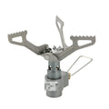 Portable gas camping stove with a one-piece metal furnace body, shown on an outdoor surface.