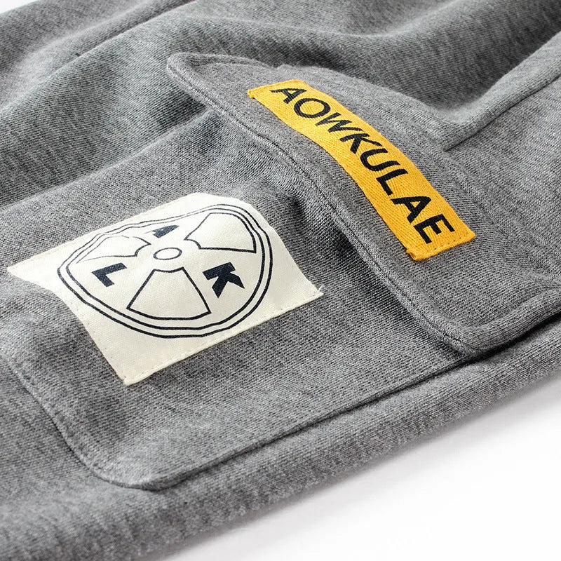 Boys' cotton track pants in black and grey, sizes 120-160cm, with elasticated hips