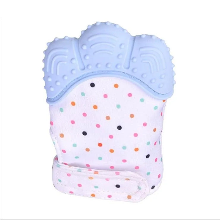 BPA-free silicone baby teether glove fastened with a white Velcro strap on a baby's hand