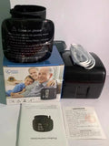 Black wrist blood pressure monitor with USB recharge port and multi-language voice feature.