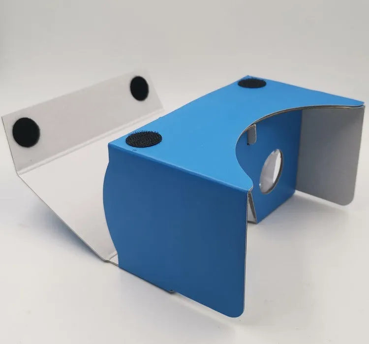 Pink and white cardboard VR glasses with 3D lenses and a rubber head strap for smartphones.