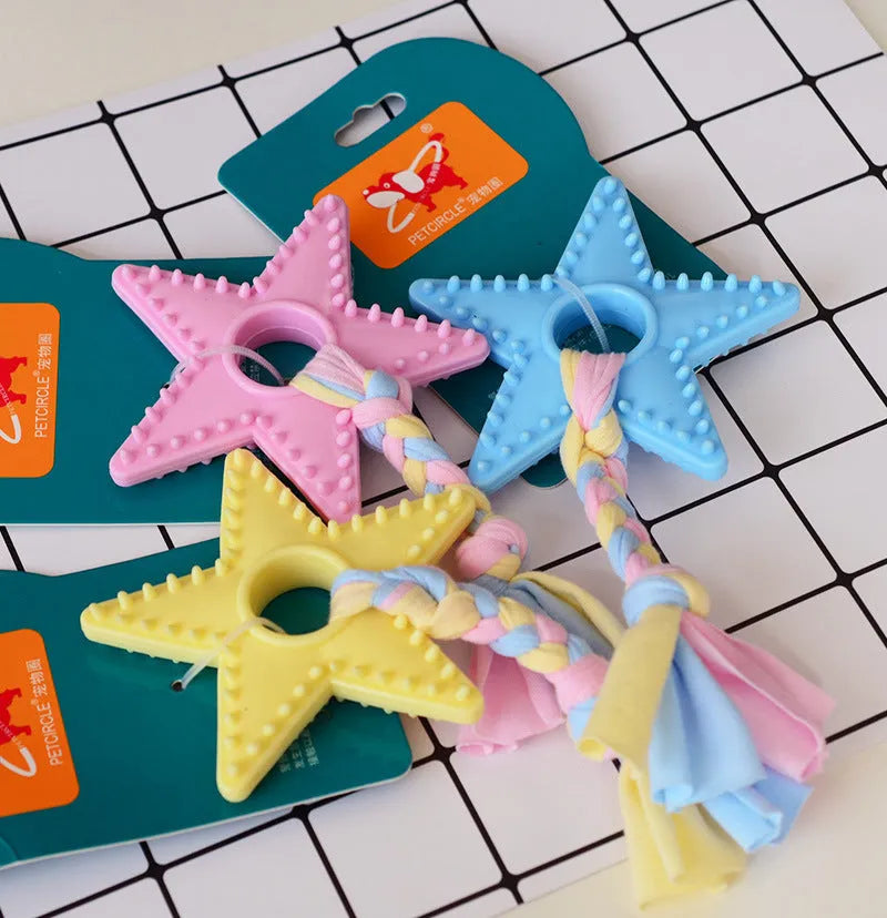Non-toxic rubber dog training toy in star shape with teeth-cleaning surface design, available in pink blue and yellow