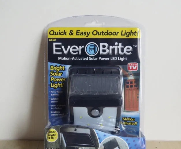 Two white outdoor solar LED security lights with four LEDs each, mounted on a wall bracket.